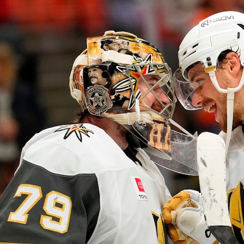 Vegas Golden Knights goaltender Carter Hart, left, and center Brett Howden congratulate each other after the Golden Knights defeated the Anaheim Ducks in Game 6 of a second-round NHL hockey Stanley Cup playoff series Thursday, May 14, 2026, in Anaheim, Calif. (AP Photo/Mark J. Terrill)