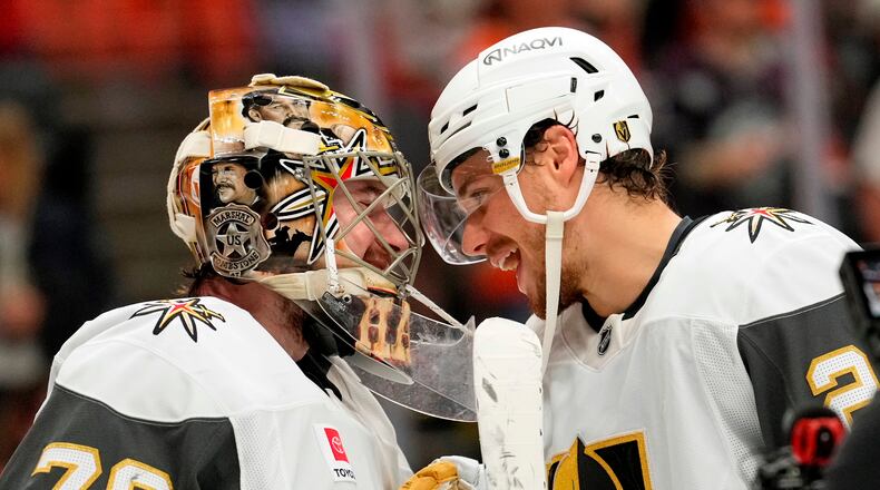 Vegas Golden Knights goaltender Carter Hart, left, and center Brett Howden congratulate each other after the Golden Knights defeated the Anaheim Ducks in Game 6 of a second-round NHL hockey Stanley Cup playoff series Thursday, May 14, 2026, in Anaheim, Calif. (AP Photo/Mark J. Terrill)
