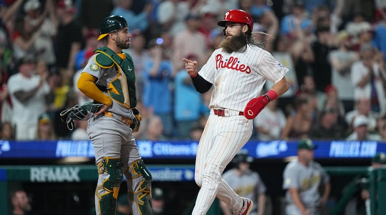 Philadelphia Phillies' Brandon Marsh scores past Athletics catcher Austin Wynns during the seventh inning of a baseball game, Tuesday, May 5, 2026, in Philadelphia. (AP Photo/Matt Rourke)
