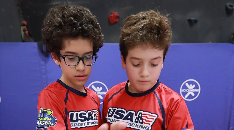 Matthew (left) and Nicholas Follmer, members of the Norcross Stackers, practice their doubles speed-stacking skills at Peachtree Elementary School on Wednesday, Aug. 29, 2018, in Peachtree Corners. CURTIS COMPTON / CCOMPTON@AJC.COM