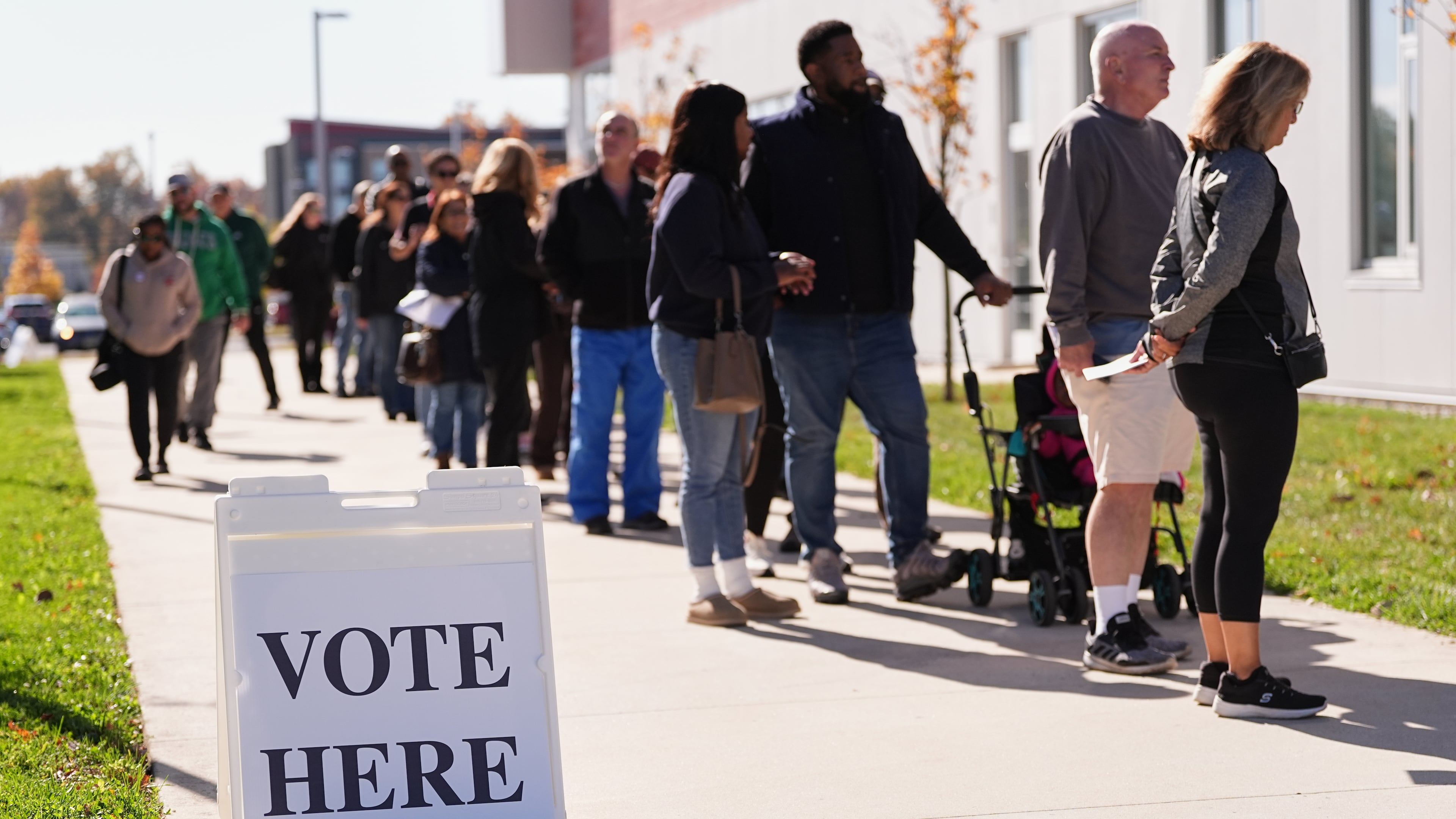 Voters wait in line to cast there ballot at a polling place at Rowan College in Mount Laurel, N.J., Monday, Oct. 27, 2025. (AP Photo/Matt Rourke)
