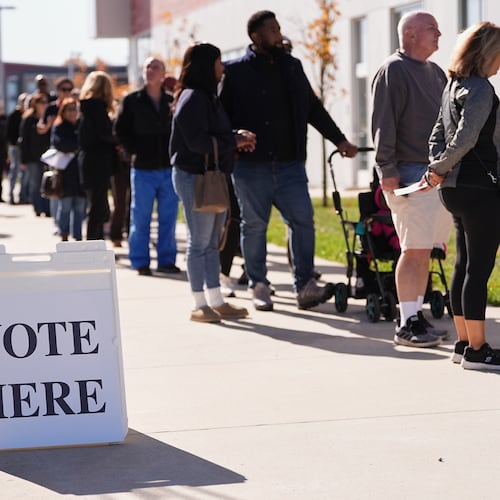 Voters wait in line to cast there ballot at a polling place at Rowan College in Mount Laurel, N.J., Monday, Oct. 27, 2025. (AP Photo/Matt Rourke)