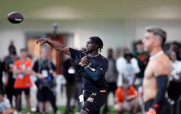 Miami quarterback Cam Ward, center, throws the ball during a drill at the school's NFL football pro day Monday, March 24, 2025. (AP Photo/Michael Laughlin)