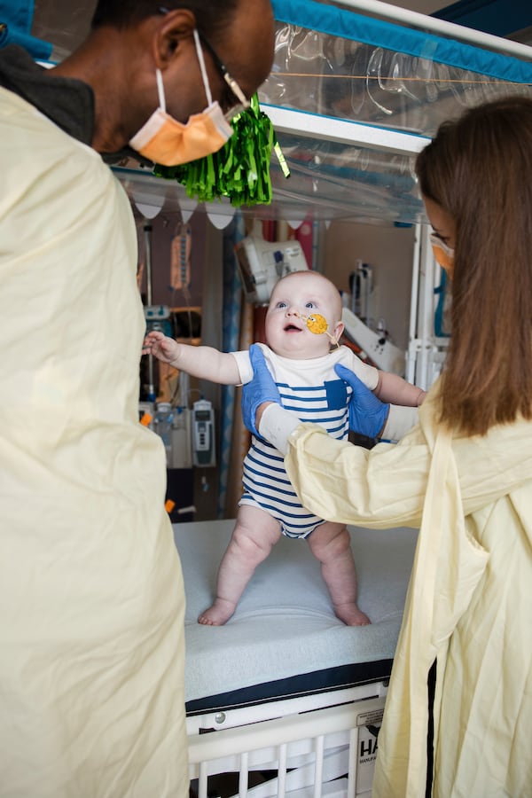 In this photo provided by the Children's Hospital of Philadelphia, Drs. Kiran Musunuru, left, and Rebecca Ahrens-Nicklas stand with KJ Muldoon, center, after a follow up dose of an experimental gene editing treatment at the hospital in April 2025. (Chloe Dawson/Children's Hospital of Philadelphia via AP)