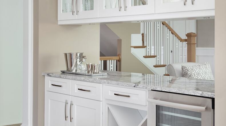 Display cabinetry, wine storage and an under-counter fridge make this beverage bar a functional and attractive part of a kitchen. Contributed by Ashton Woods