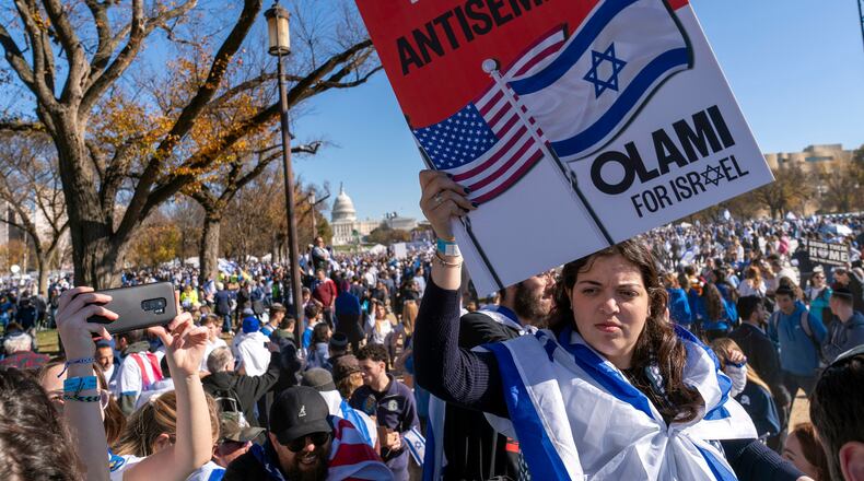 FILE - A woman holds a sign saying, "end antisemitism" while attending a March for Israel rally Nov. 14, 2023, on the National Mall in Washington. (AP Photo/Jacquelyn Martin, File)