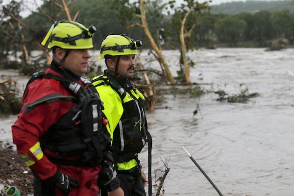 Kerrville Fire Department first responders scan the banks of the Guadalupe River for individuals swept away by flooding in Ingram, Texas, Thursday, July 4, 2025. (Michel Fortier/The San Antonio Express-News via AP)
