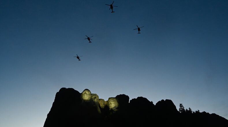 FILE - UH-60 Black Hawk helicopters perform a flyover as Interior Secretary Doug Burgum speaks before President Donald Trump at Mount Rushmore National Memorial, July 3, 2026, near Keystone, S.D. (AP Photo/Matt Gade, File)