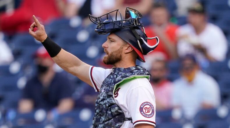 Washington Nationals catcher Jonathan Lucroy gestures in the seventh inning of an opening day baseball game against the Atlanta Braves at Nationals Park, Tuesday, April 6, 2021, in Washington. (AP Photo/Alex Brandon)