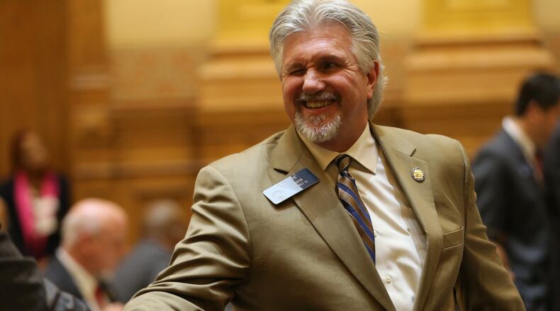 Sen. Greg Kirk (R-Americus) winks and shakes hands after the “religious liberty” bill he sponsored in the Senate passed on March 16. Ben Gray / bgray@ajc.com