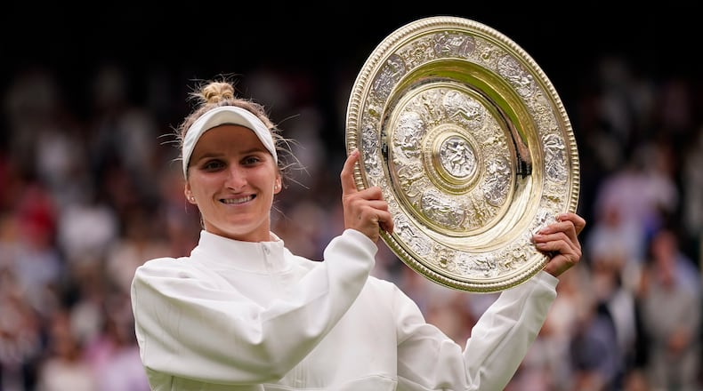 FILE - Czech Republic's Marketa Vondrousova celebrates with the trophy after beating Tunisia's Ons Jabeur to win the final of the women's singles on day thirteen of the Wimbledon tennis championships in London, Saturday, July 15, 2023. (AP Photo/Alberto Pezzali, file)
