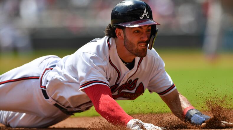 Atlanta Braves Dansby Swanson dives into third, but not before the tag of Philadelphia Phillies third baseman Maikel Franco at SunTrust Park Saturday September 22, 2018.  Photo by Brant Sanderlin/AJC