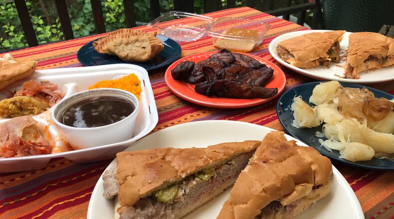 Havana Sandwich Shop specializes in affordably priced Cuban classics. Pictured, clockwise from left, are a tamale plate, empanadas, maduros (sweet fried plantains), flan, a ropa vieja sandwich, yuca con mojo and a Cuban sandwich. LIGAYA FIGUERAS/LIGAYA.FIGUERAS@AJC.COM