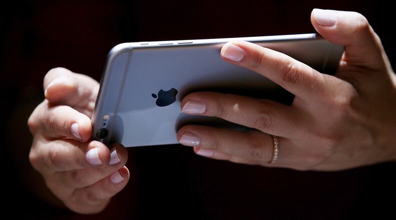 CUPERTINO, CA - SEPTEMBER 09: A member of the media inspects the new iPhone 6 during an Apple special event at the Flint Center for the Performing Arts on September 9, 2014 in Cupertino, California. Apple unveiled the Apple Watch wearable tech and two new iPhones, the iPhone 6 and iPhone 6 Plus. (Photo by Justin Sullivan/Getty Images)