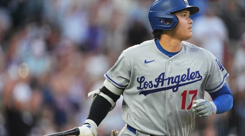 Los Angeles Dodgers' Shohei Ohtani drops his bat as he heads up the first-base line after hitting a two-run home run off Colorado Rockies starting pitcher Ryan Feltner in the third inning of a baseball game Tuesday, Aug. 18, 2026, in Denver. (AP Photo/David Zalubowski)