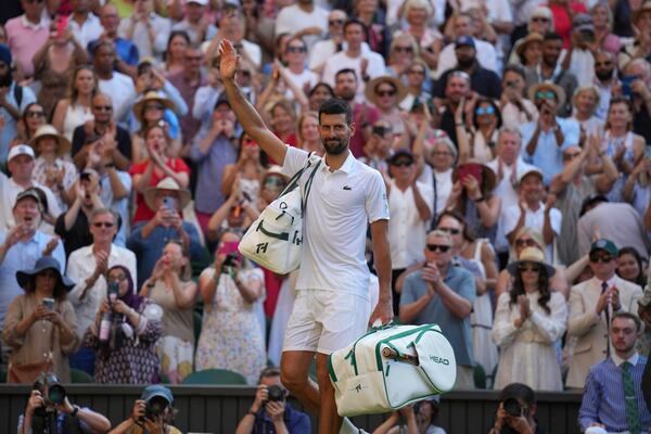Serbia's Novak Djokovic leaves the court after losing to Italy's Jannik Sinner in a men's singles semifinal at the Wimbledon Tennis Championships in London, Friday, July 11, 2025. (AP Photo/Kin Cheung)
