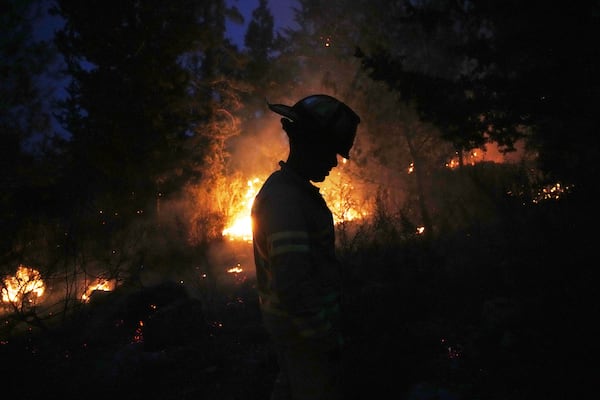 An Israeli firefighter works as forest fire is burning near Jerusalem, Wednesday, April 30, 2025. (AP Photo/Ohad Zwigenberg)