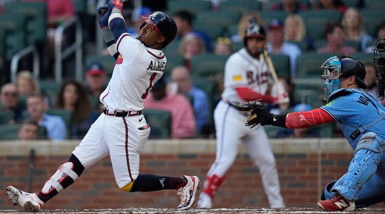 Atlanta Braves second baseman Ozzie Albies (1) hits a sacrifice fly for an RBI in the first inning of a baseball game against the Toronto Blue Jays, Tuesday, June 2, 2026, in Atlanta. (AP Photo/Mike Stewart)