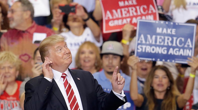 President Donald Trump gestures to the crowd while speaking at a rally at the Phoenix Convention Center, Tuesday, Aug. 22, 2017, in Phoenix. (AP Photo/Rick Scuteri)