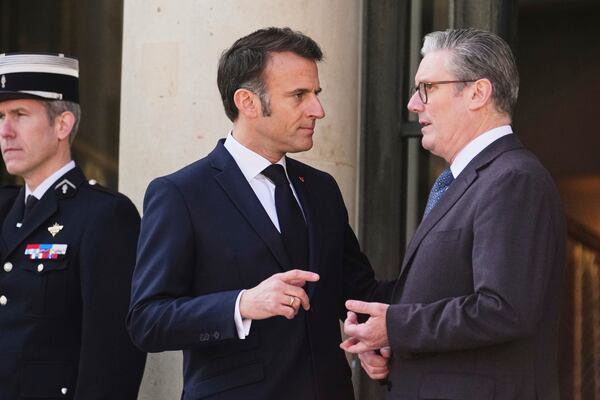 French President Emmanuel Macron, center, speaks with Britain's Prime Minister Keir Starmer during arrivals for a summit on Ukraine at the Elysee Palace in Paris, Thursday, March 27, 2025 . (AP Photo/Thibault Camus)