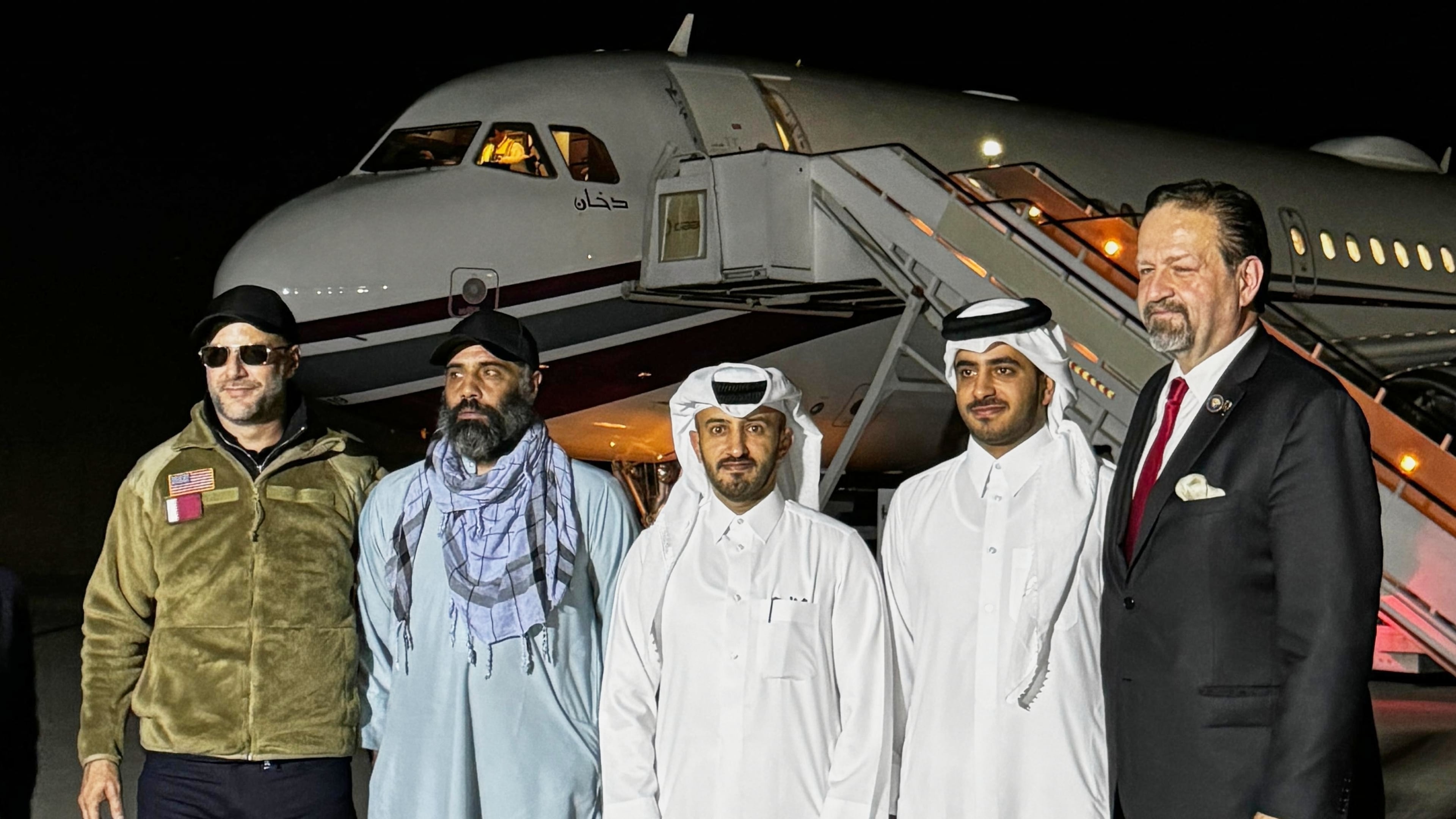 In this photo released by Qatar's Foreign Ministry, U.S. citizen Amir Amiri, second from left, poses before boarding a plane in Kabul, Afghanistan, on Sunday, Sept. 28, 2025, after being released from an Afghan prison. With him, from right, Deputy Assistant to the U.S. President Sebastian Gorka, an unidentified Qatari diplomat, Charge d'Affaires of the Embassy of the State of Qatar in Afghanistan Dr. Mirdef Al Qashouti, centre, and, left, U.S. Special Envoy for Hostage Response Adam Boehler. (Qatar Foreign Ministry via AP)