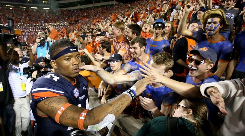 Auburn quarterback Nick Marshall (14) celebrates the Tigers’ 43-38 win over Georgia at Auburn’s Jordan-Hare Stadium last season. JASON GETZ / AJC