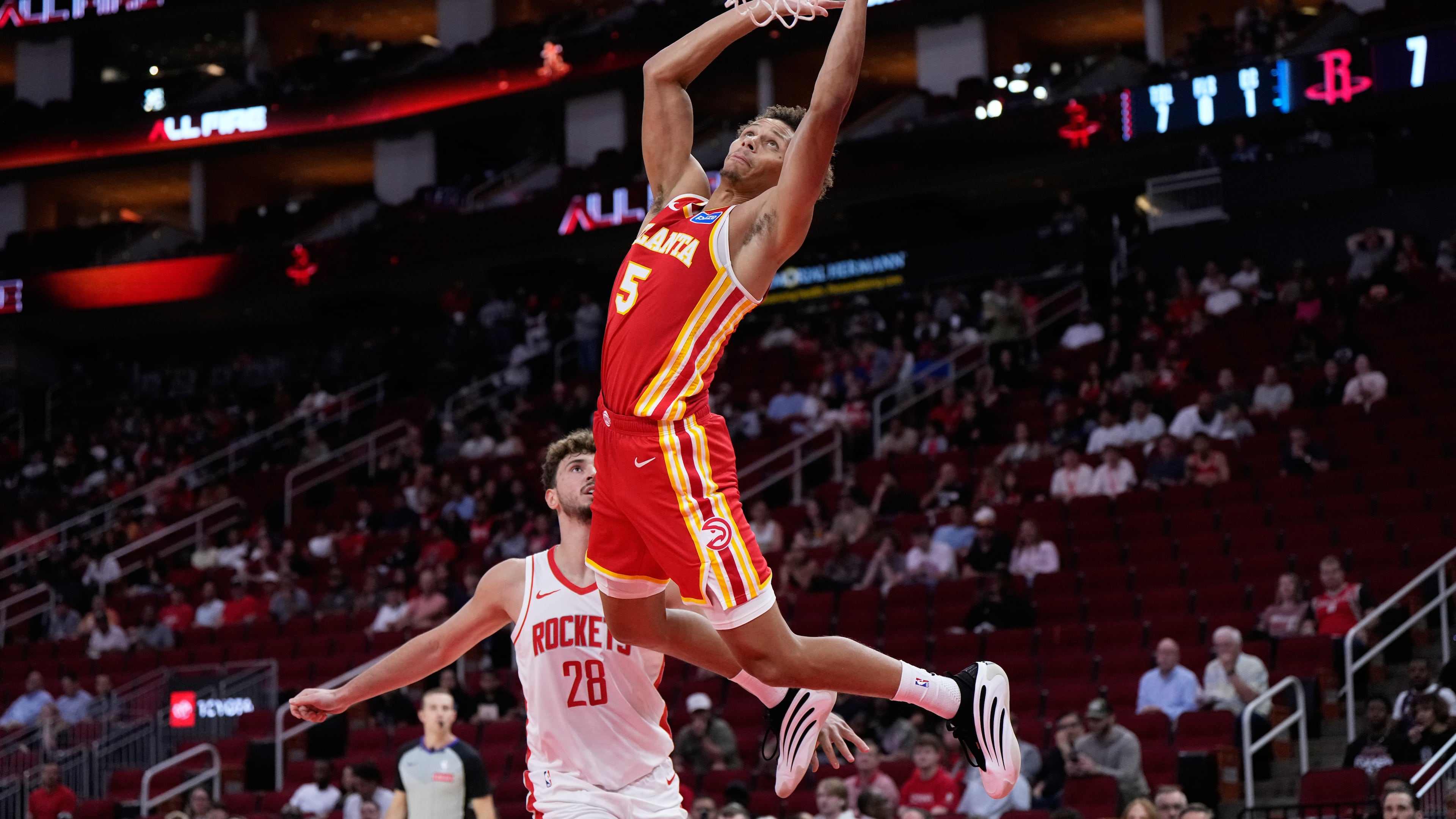 Atlanta Hawks guard Dyson Daniels (5) shoots against Houston Rockets center Alperen Sengun (28) during the first half of an NBA basketball preseason game in Houston, Monday, Oct. 6, 2025. (AP Photo/Ashley Landis)