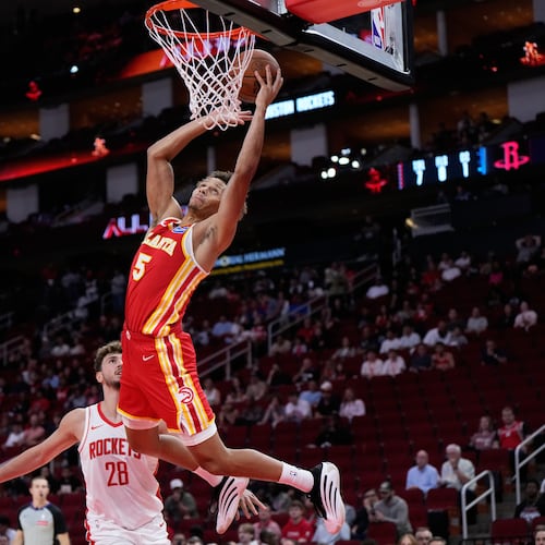 Atlanta Hawks guard Dyson Daniels (5) shoots against Houston Rockets center Alperen Sengun (28) during the first half of an NBA basketball preseason game in Houston, Monday, Oct. 6, 2025. (AP Photo/Ashley Landis)