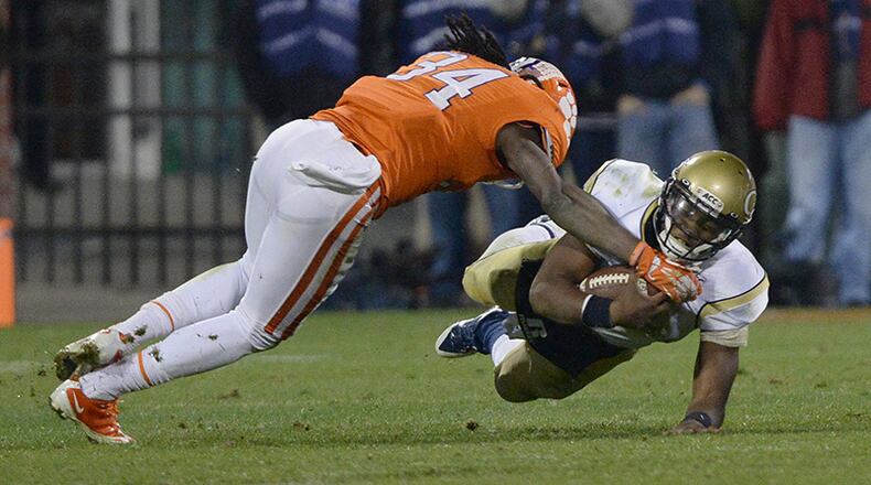 November 14, 2013 - Clemson, SC: Georgia Tech's Vad Lee (2) is tackled by Clemson's Quandon Christian inside Memorial Stadium in Clemson, South Carolina on Thursday, November 14, 2013. Tech lost the game 55 to 31. JOHNNY CRAWFORD / JCRAWFORD@AJC.COM Georgia Tech will clash with Clemson on Nov. 15. (Johnny Crawford / AJC File)