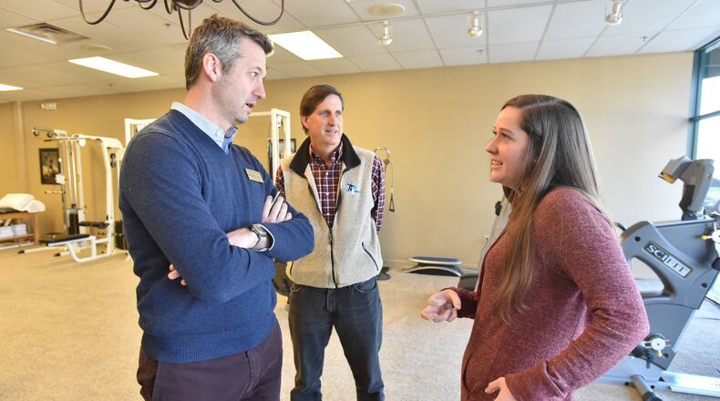 Caroline Freemeyer consults physical therapist Steven Owens (left) as her father, Jeff Freemeyer, looks on. Jeff Freemeyer did everything he was supposed to do in looking for his family’s 2018 health insurance policy, making sure their doctors and facilities were in network. Then as soon as the new year turned and Caroline needed her long-term doctor, it turned out they actually weren’t. Georgians on the individual health insurance market, both Affordable Care Act exchanges and not, are seeing changes that amount to a wholesale shift. HYOSUB SHIN / HSHIN@AJC.COM