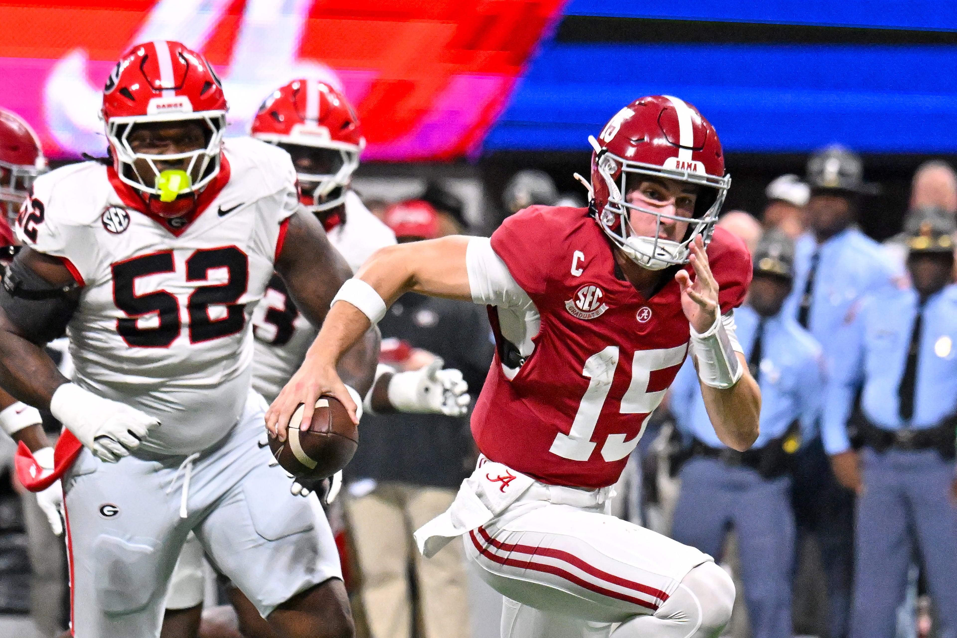 Alabama quarterback Ty Simpson (15) scrambles in the pocket under pressure from the Georgia defense during the third quarter of the SEC Championship game at Mercedes-Benz Stadium, Saturday, Dec. 6, 2025, in Atlanta. (Hyosub Shin / AJC)