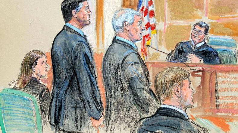 This courtroom sketch depicts former FBI Director James Comey, second from left, and his attorneys Jessica Carmichael, seated left, and Patrick J. Fitzgerald, standing right, during his arraignment at the federal courthouse in Alexandria, Va., Wednesday, Oct. 8, 2025. Assistant U.S. Attorney Tyler Lemons, is seated right. (Dana Verkouteren via AP)