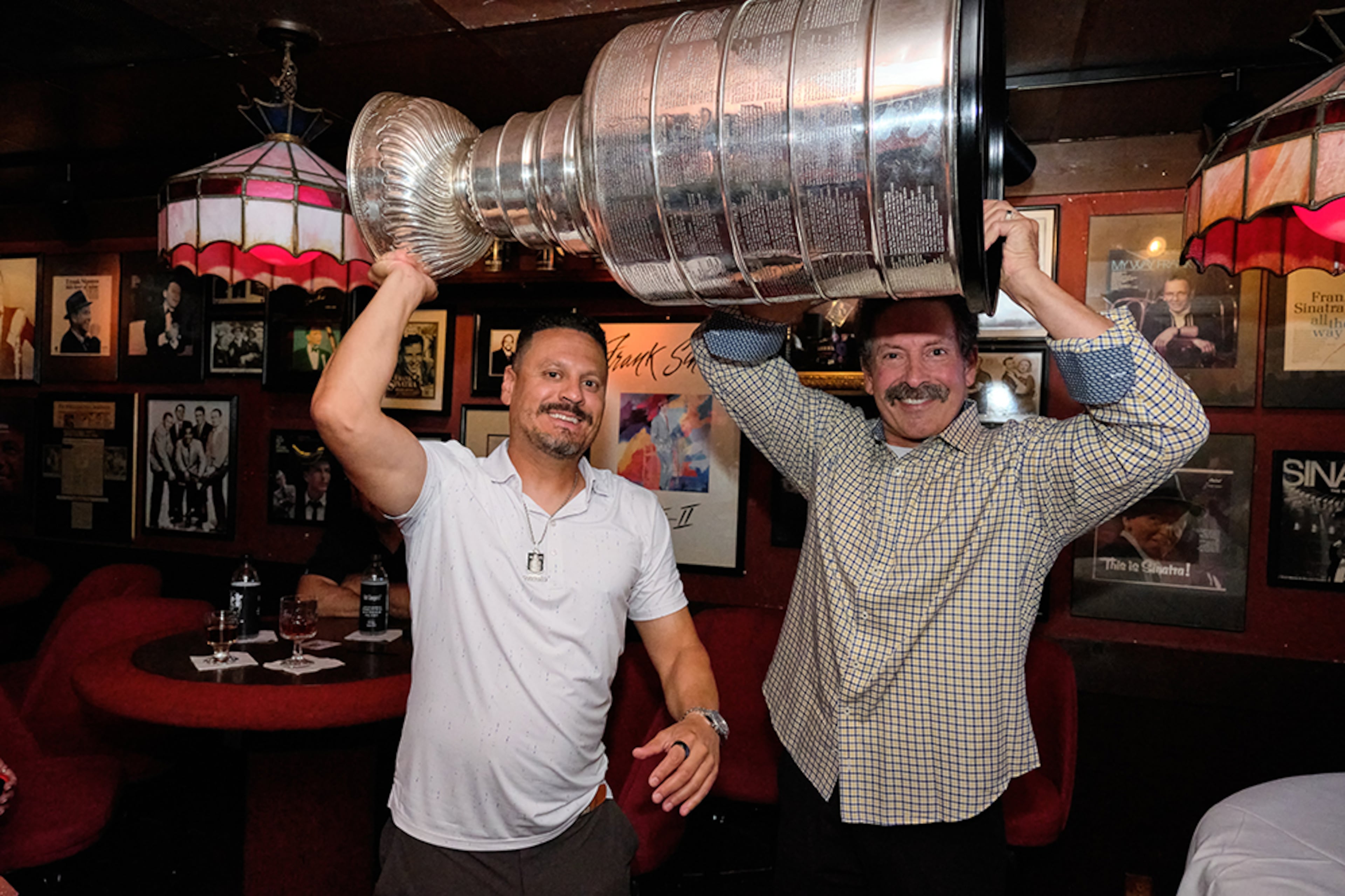 Mike Huff (left) with Chris D'Auria, the owner of Johnny's Hideaway. The Stanley Cup made an appearance at Johnny's Hideaway on Tuesday, July 15. (Credit: Brandon Amato, courtesy of Johnny's Hideaway)
