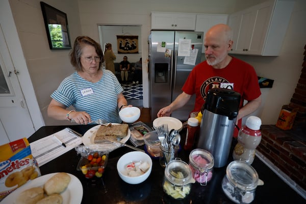 Volunteers Lauren and Arthur Waits prepare meals for the visitors at El Refugio, a place that offers free accommodation and meals for immigrant families who come to see their relatives at Stewart Detention Center. (Miguel Martinez/AJC)