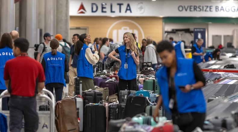 Delta Air Lines employees were busy Wednesday, July 24, 2024, at Hartsfield-Jackson International Airport as operations started to recover from a meltdown that left hundreds of thousands of travelers stranded around the country. (John Spink/AJC)