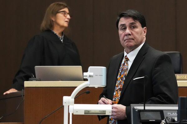 Judge Victoria A. Rossetti, top left, and Robert E. Crimo III's attorney Gregory Ticsay wait for Lake County Assistant State's Attorney Ben Dillon during the sentencing hearing for Robert E. Crimo III., at the Lake County Courthouse, in Waukegan, Ill., Wednesday, April 23, 2025. (AP Photo/Nam Y. Huh, Pool)