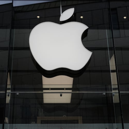 FILE - The Apple logo is illuminated at a store in Munich, April 2, 2026. (AP Photo/Matthias Schrader, File)