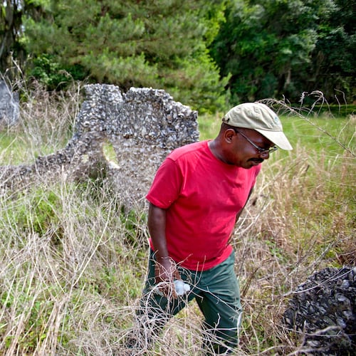 FILE - Ire Gene Grovner walks through remnants of the old slave's quarters at the Chocolate Plantation where his ancestors lived some eight generations ago on Sapelo Island, Ga., on May 16, 2013. (AP Photo/David Goldman, File)