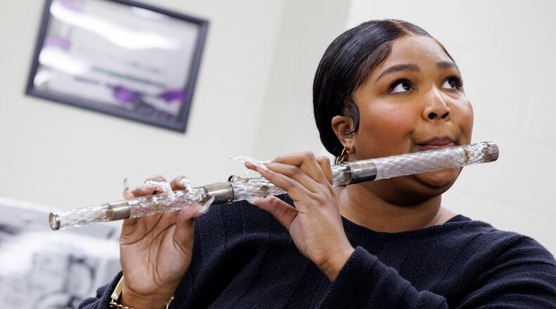 A photo provided by Shawn Miller and the Library of Congress shows Lizzo practicing with James Madison’s flute before bringing it onstage during her concert at Capital One Arena in Washington. A classically trained flutist, the singer, rapper and songwriter spent more than three hours admiring the flute collection at the Library of Congress. (Shawn Miller/Library of Congress via The New York Times) — EDITORIAL USE ONLY—