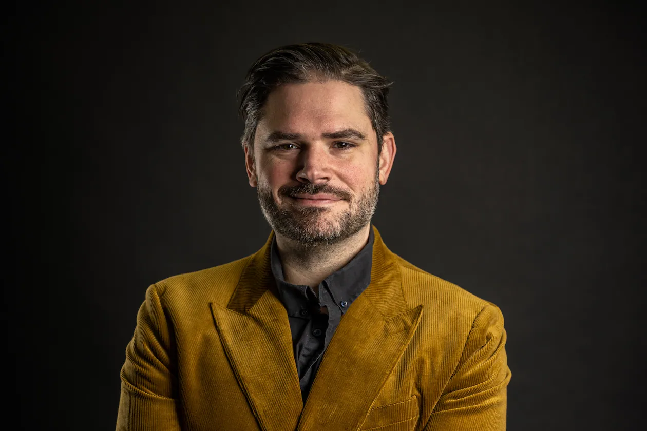 Jeff Banks, a professional Atlanta mixologist, is standing in a confident pose with a smile and crossed arms. He is the only bartender from the Southeast competing in the World Class Bartender competition finals this May.