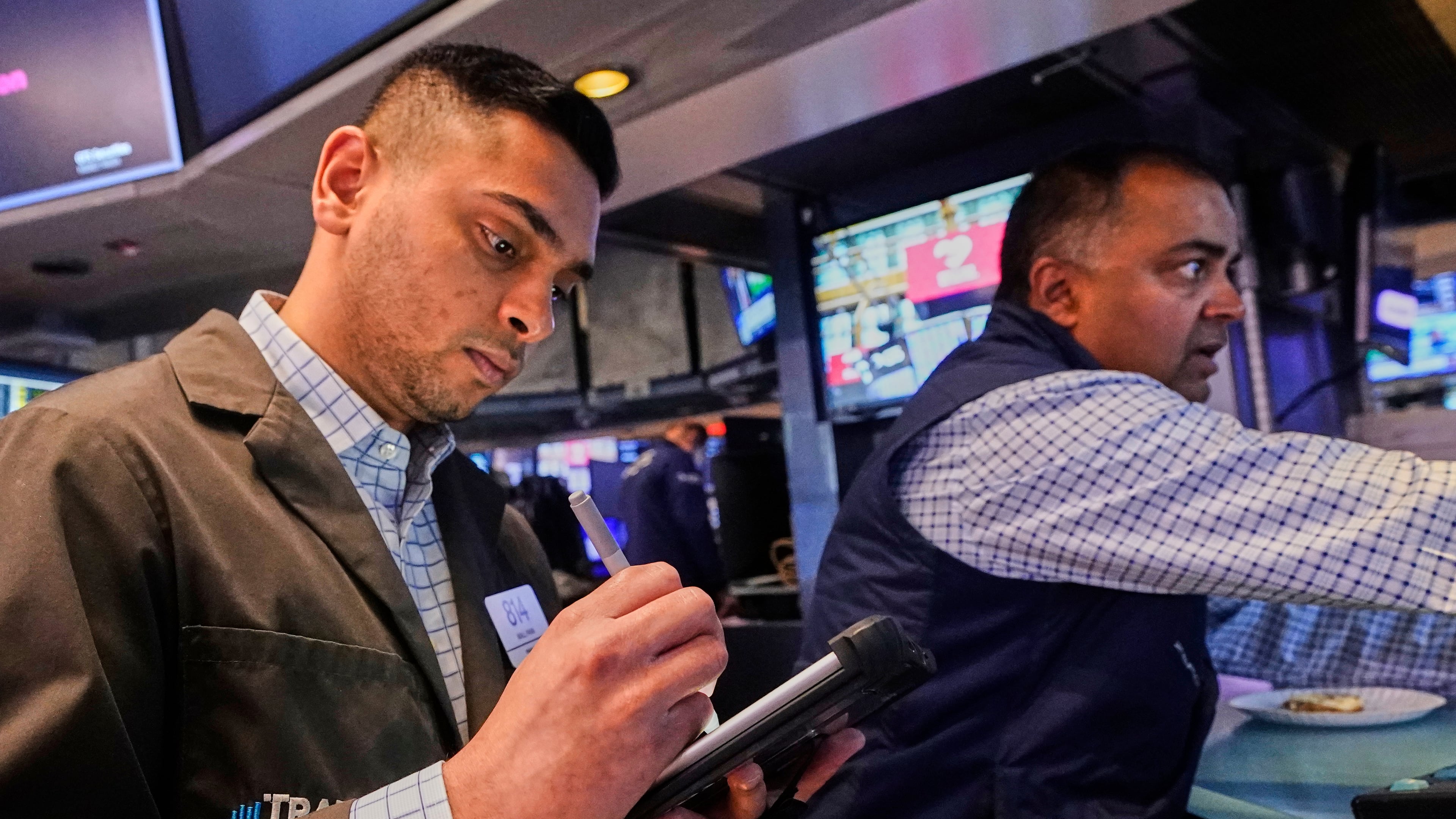 Trader Niall Pawa, left, and specialist Dilip Patel work on the floor of the New York Stock Exchange, Wednesday, Sept. 10, 2025. (AP Photo/Richard Drew)