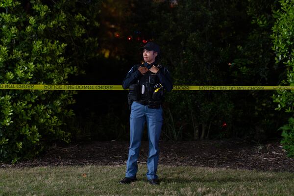 A Cobb County police officer guards the scene where a massive search for Damian Strozier ended late Tuesday in the area of Leland and Windy Hill roads. (Ben Hendren for the AJC)