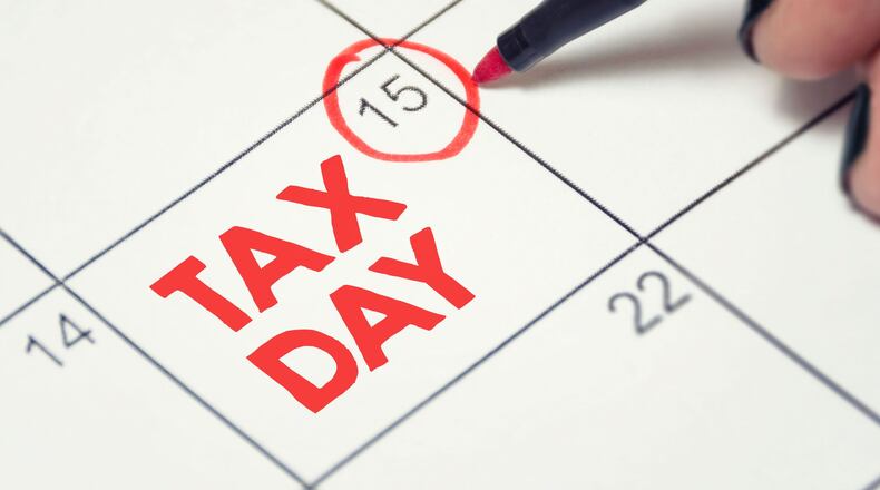 April 15 date circled in red on calendar, with the words TAX DAY written in red letters on that calendar square.