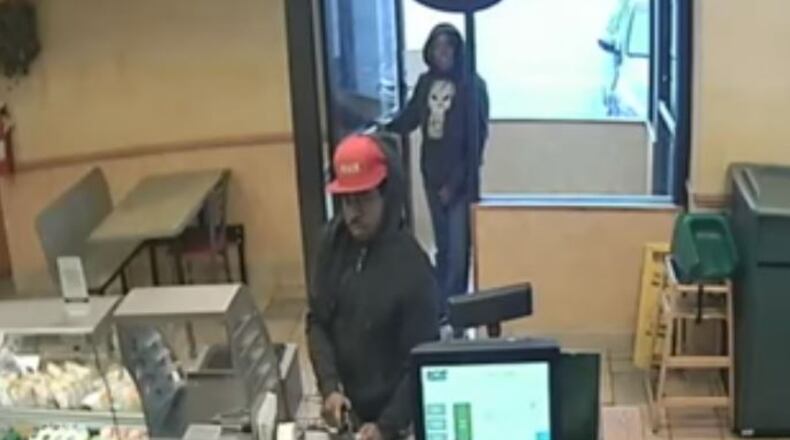 DeKalb police say they are searching for these two accused Subway robbers.