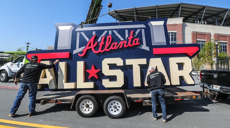 Workers load the All Star sign after removing it from near Truist Park's scoreboard on April 6, 2021. (John Spink/john.spink@ajc.com)