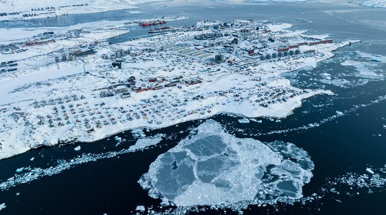 FILE - Houses covered by snow are seen on the coast of a sea inlet of Nuuk, Greenland, on March 7, 2025. (AP Photo/Evgeniy Maloletka, File)