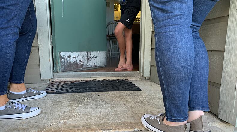 Teachers from Rawlinson Middle School in San Antonio go door to door to find students who have stopped logging in for class during the COVID-19 pandemic. They knock until someone answers, and talk to sleepy kids and overwhelmed parents about how to stay engaged during remote learning. (Bekah McNeel)