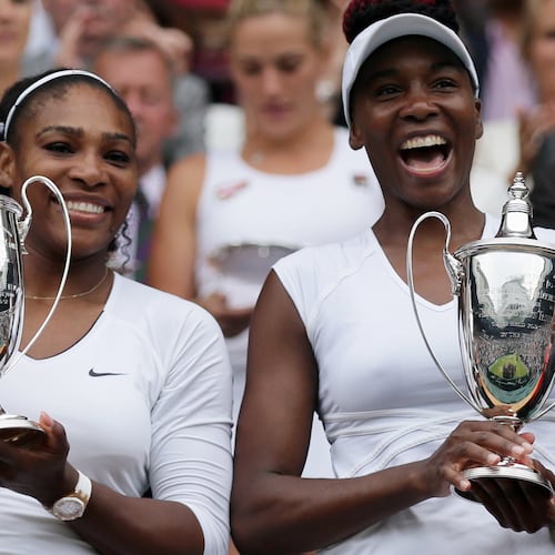 FILE -Serena Williams, left, and Venus Williams of the U.S hold their trophies after winning the women's doubles final against Yaroslava Shvedova of Kazahkstan and Timea Babos of Hungary on day thirteen of the Wimbledon Tennis Championships in London, July 9, 2016. (AP Photo/Tim Ireland, File)