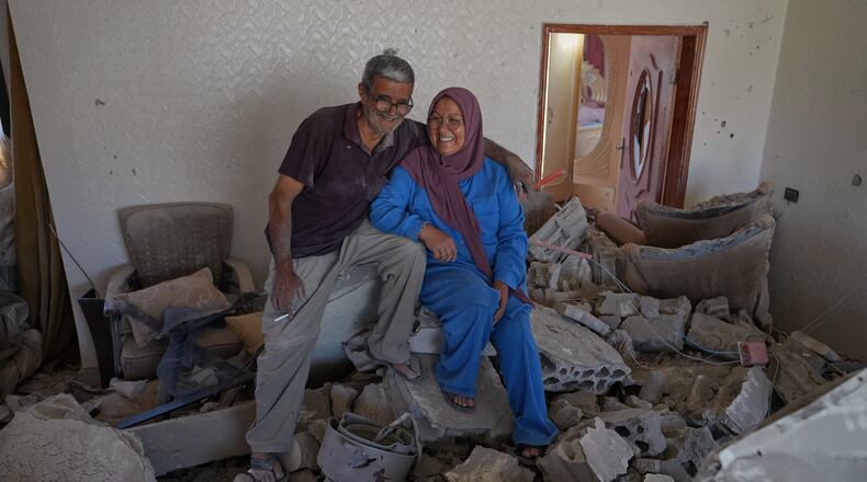 Mahasen Faqih and her husband, Mohammed Sobeih, smile as they sit amid the rubble of their home after returning to it following the Israeli military operation in Zawtar al-Gharbieh, Lebanon, Tuesday, July 28, 2026. (AP Photo/Hassan Ammar)