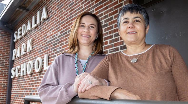 Cobb County Schools social worker Julie Lance (left) stands with Liz Platner, founder of the all-volunteer PORCH-Marietta. The organization helps with food and snacks for kids, at Sedalia Park Elementary School in Marietta. PHIL SKINNER FOR THE ATLANTA JOURNAL-CONSTITUTION